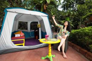 a woman sitting on a table in front of a tent at SUNWAY LAGOON SDN BHD in Subang Jaya