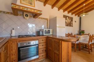 a kitchen with a counter top and a stove top oven at Es Coll den Pastor in Sóller