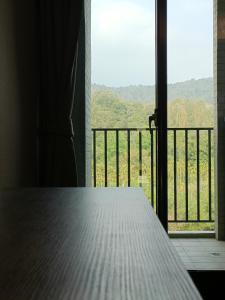 a room with a window with a view of a field at The Deer Resort in Yuchi