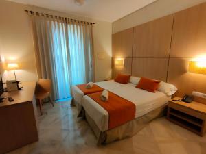 A bed or beds in a room at Hotel Boutique Convento Cádiz