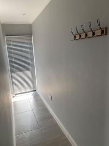 an empty room with a hallway with a window at Maîté Iphupho in Somerset West +10 photos
