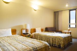 Postel nebo postele na pokoji v ubytování Hotel Gyokusen