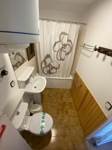 a bathroom with a toilet and a shower curtain at Gran Duc Pedrous in Pas de la Casa