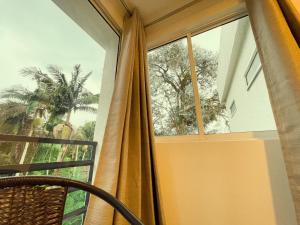 聖羅莎德卡瓦爾的住宿－Hotel Campestre Villa Mary，带窗帘和椅子的窗户的房间