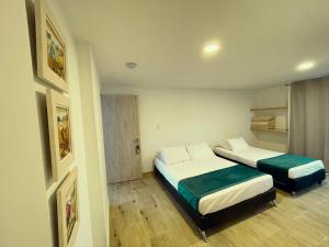 Postel nebo postele na pokoji v ubytování Hotel Campestre Villa Mary