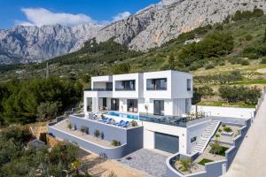 a house with a view of a mountain at NEW Luxury Villa Sagnia, 4 en-suite bedrooms, sea views in Makarska