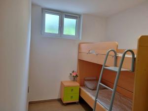 a bedroom with two bunk beds and a window at Apartma Piko in Koper