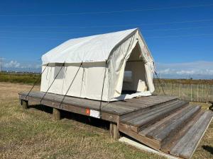 a tent sitting on a trailer in a field at Tentrr State Park Site - Texas Galveston Island- Beachside E - Single Camp in Galveston