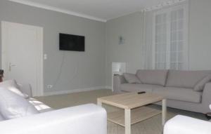 a living room with a couch and a table at Gite de Saint Jean in Saint-Jean-de-Thouars