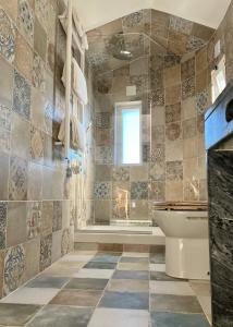 a bathroom with a toilet and a sink at The Globetrotter's Inn in Ericeira