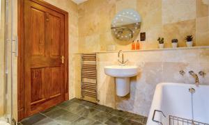 a bathroom with a sink and a bath tub and a sink at Silver Howe in Bowness-on-Windermere +17 photos
