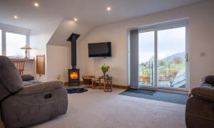a living room with a couch and a fireplace at Sherriff in Penrith