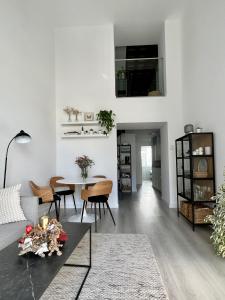 a living room with a couch and a table at Apartamento Duplex casa Palacio rehabilitado centro El Puerto in El Puerto de Santa María