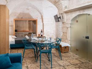 a room with a table and chairs and a bed at Dama Bianca Boutique Hotel Ostuni in Ostuni