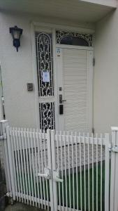 Una porta bianca su una casa con una recinzione bianca di Toride - House / Vacation STAY 4015 a Toride
