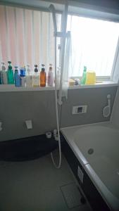 a bathroom with a shower and a sink and a tub at Toride - House / Vacation STAY 4015 in Toride