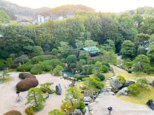 an aerial view of a garden with a pond at Hotel Gyokusen in Matsue
