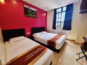Postel nebo postele na pokoji v ubytování Hotel Sun Birds