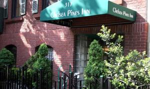 a brick building with a sign that reads casa pines inn at Chelsea Pines Inn in New York