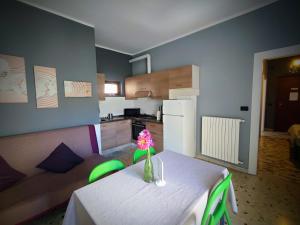 a living room with a table and a kitchen at Dianostellamarina in Diano Marina