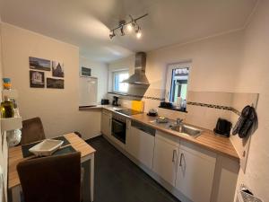a kitchen with a sink and a counter top at Ferienwohnung Am Bachlauf in Pommern