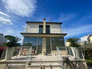 a house with a staircase leading up to it at Villa I tre Cipressi in Lido di Camaiore