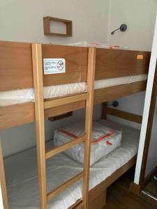 a group of bunk beds in a room at Studio Cabine Pornichet Vue Mer 4 pers in Pornichet