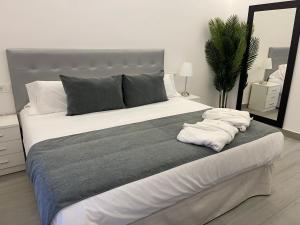 a bedroom with a large bed with towels on it at SUARA Apartamentos 1 in Madrid