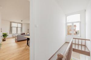 an apartment with a staircase and a living room at SurPRIMO - Gerenoveerd appartement in Antwerp