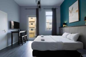 Krevet ili kreveti u jedinici u okviru objekta Liber Tel Aviv Sea Shore Suites BY RAPHAEL HOTELS