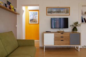 a living room with a couch and a tv at Gli Appartamenti Dell' Architetto in Trapani