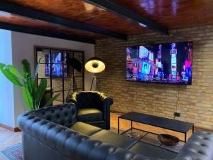 a living room with a couch and a tv on a brick wall at Residence Bruno in Foggia
