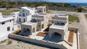 an aerial view of a white house with the ocean at Christos Place-Paleochora in Palaiochora