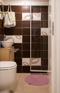 a bathroom with a shower with a toilet and a sink at Gli Appartamenti Dell' Architetto in Trapani