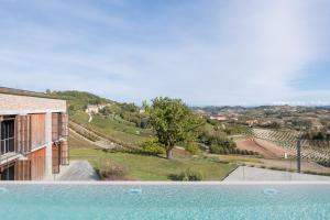 a view of a house with a swimming pool at Ca' del Profeta Ristorante & Relais in Montegrosso dʼAsti