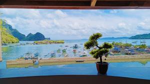 a large window with a view of a body of water at SG Tourist Inn in El Nido
