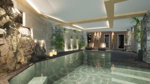 a swimming pool in a house with a stone wall at Mikro Papigo 1700 Hotel & Spa in Papingo
