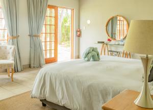 a bedroom with a bed with a stuffed animal on it at Hopefield BnB in Addo