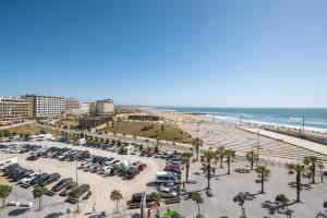 an aerial view of a parking lot at the beach at Costa Beach Apartment by The Portuguese Butler in Costa da Caparica