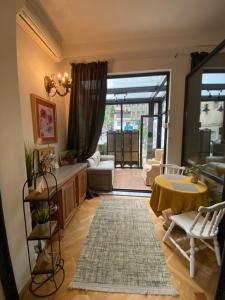 a living room with a couch and a table at Piccolo Casa Bella Hotel in Tbilisi City