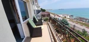 a balcony of a building with a view of the ocean at Vila Jolie in Costinesti