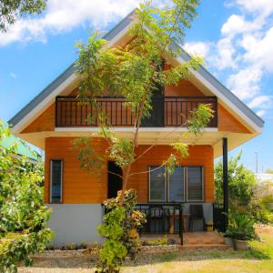 a house with a balcony on the side of it at Ana-as Apartelle (GGL) in Panglao Island