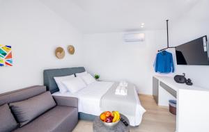 a living room with a bed and a couch at Sunwaves Beach studio I in Ialyssos