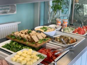 a buffet with a lot of food on a counter at Pod Wydmą in Unieście