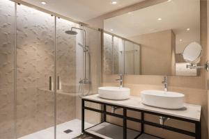 a bathroom with two sinks and a shower at Exe Coruña in A Coruña