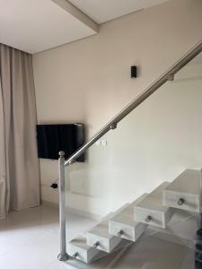 a staircase in a room with white walls at Cozy new townhouse for 6 people! in Salalah