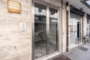 a glass door of a building with a car in it at Home Abate Gimma 170 in Bari