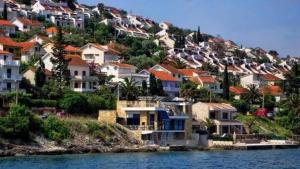 a bunch of houses on a hill next to the water at Studio Happy Montenegro in Krasici