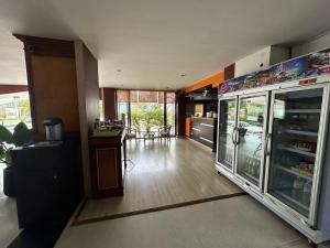 a room with a kitchen with a large refrigerator at Bordin Hotel in Ubon Ratchathani +20 photos