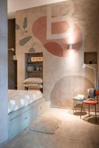 a bedroom with a bed and a desk and a chair at Loft B in Turin